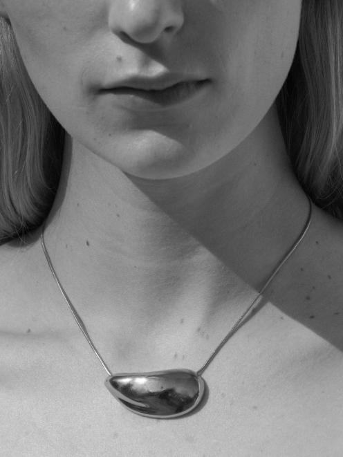 Sophie's Oyster necklace is a teardrop-shaped silver pendant that sits on its side and nestles...