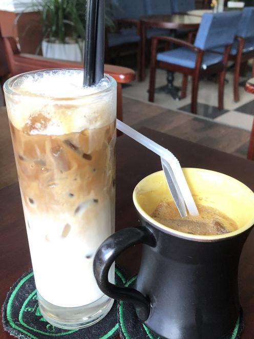 An iced ‘‘white coffee’’ made with milk and condensed milk alongside an iced ‘‘milk coffee’’ —...