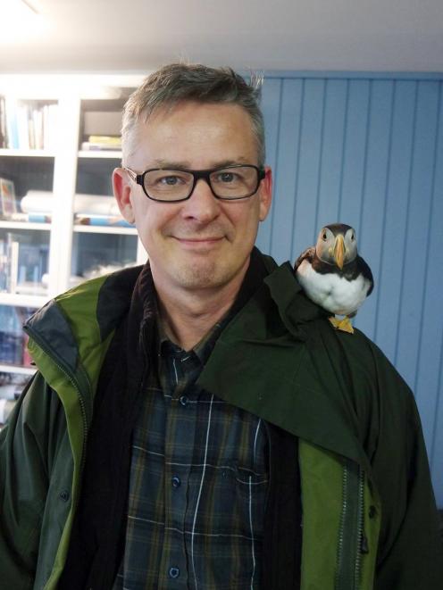 Dr Erpur Hansen, director of the South Iceland Nature Research Centre with Toti the puffin. Photo...