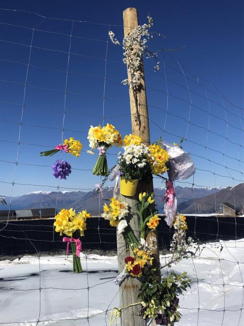 Flowers were laid to remember the woman who died in a skiing accident at Coronet Peak on Saturday. Photo: Supplied