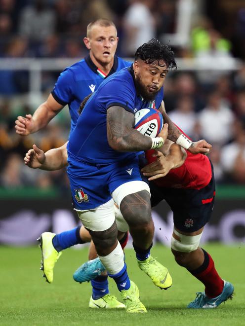 Italy loose forward Jimmy Tuivaiti attempts to break clear against England at St James’ Park in...