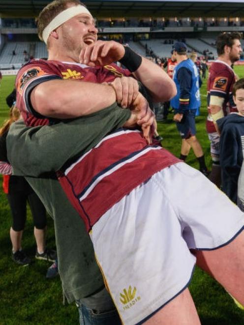 Southland's Ryan Carter gets a hug from a jubilant supporter after the game. The Stags' 42-14 win...