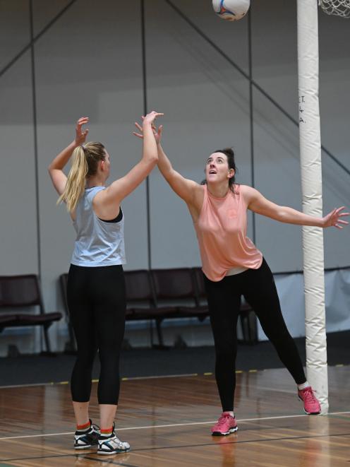 Alex Taal (left) takes a shot at goal under pressure from Ellen Kirkwood as the Otago team trains...