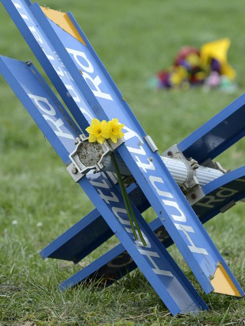 Floral tributes have been placed at the scene of Tuesday's fatal crash near Outram. Photo: Staff Photographer