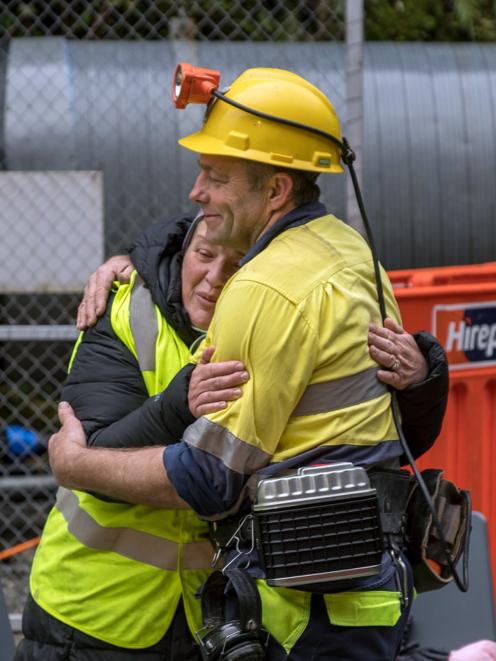 Anna Osborne and Scotty Campbell have a hug at the Pike River Mine portal yesterday. PHOTO:...