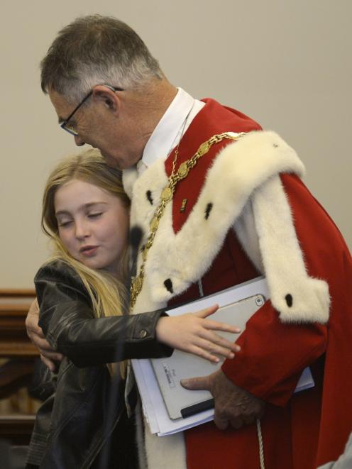 Outgoing Dunedin Mayor Dave Cull shares a hug with 9-year-old granddaughter Carli Hutchinson before the start of his final council meeting yesterday. Photo: Gerard O'Brien