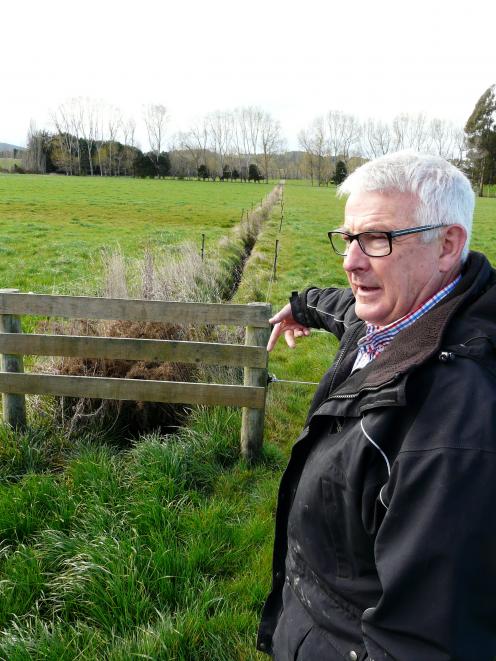 Otago South River Care project facilitator Lloyd McCall inspects a dairy paddock drain. PHOTO: RICHARD DAVISON