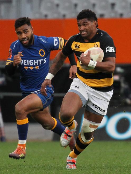 Waisake Naholo, playing for Taranaki against Otago last month, runs hard at Forsyth Barr Stadium, as Jona Nareki gives chase. Photo: Getty Images