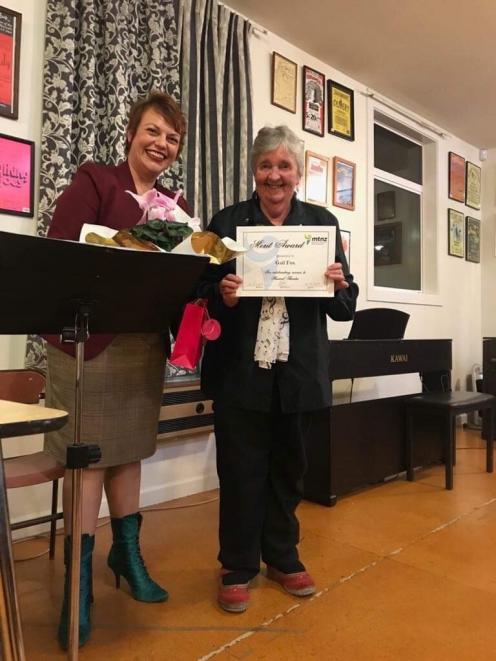 Gail Fox holds the merit award, presented by North Canterbury Musicals' president, Michelle Hampton.