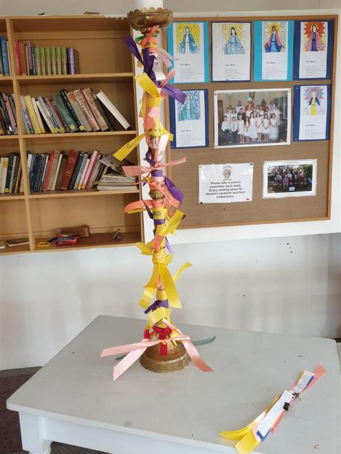 Ribbons tied to a candlestick, on display at Alexandra's Catholic Church of St John the Baptist, do not do enough to support victims of sexual abuse within the church, a survivor says. Photo: Supplied