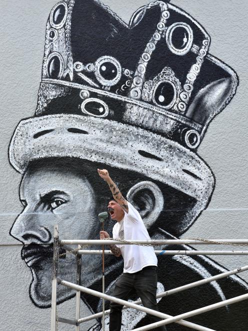 Dunedin artist Bruce Mahalski does his best Freddie Mercury impression in front of his Queen St...