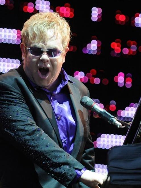 Sir Elton John belts out a hit in Dunedin's Forsyth Barr Stadium last night. Photo by Craig Baxter.