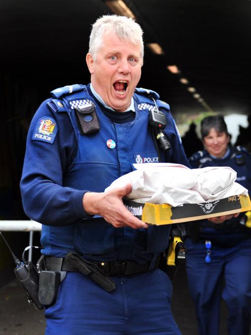 Senior Community Constable Fred Jansen delivers hot chips to mural-painting children. PHOTOS:...