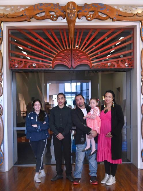 Master carver James York and family members (from left) Mia Wereta (15),Nukuroa McLean (15), Aniwa York (4), and Amber Bridgman take a moment to reflect under Te Ohaka a Toroa(The Nest of the Albatross), at Toitu Otago Settlers Museum shortly after the un