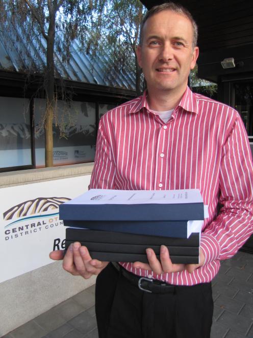 Central Otago District Council planning manager David Campbell holds the 2199-page agenda for the...