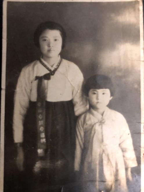 Koh’s mother as a young girl with her aunt. Her mother carried the photograph with her after her aunt got caught behind the 38th Parallel, never to be seen again.