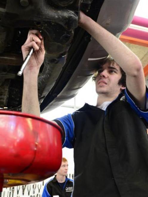 Otago Polytechnic automotive engineering student Issac Sonntag (18) works on an oil change, with...
