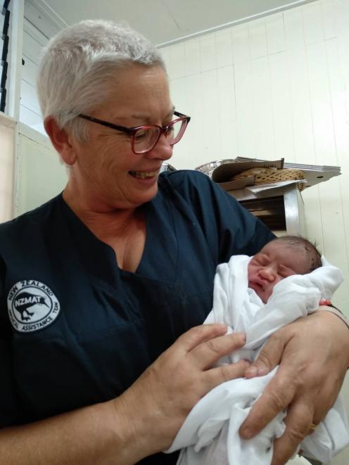 Invercargill nurse Anne Dymond holds baby Annegelo — a baby she delivered while at Leulemoega Hospital in Samoa while helping with the measles epidemic. Photo: Supplied