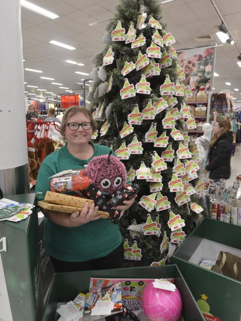 Kmart wishing tree ‘‘champion’’ Dawn Barnes sorts donated presents. Photo: Gerard O'Brien