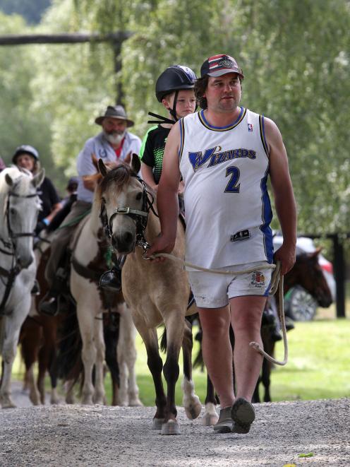 Six-year-old Ridge Kenny is led by his father, Jimmy, while his grandfather, trek trail boss...
