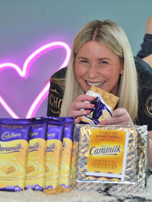 Former Cadbury worker Megan Fairley sells the last 20 blocks of Dunedin Caramilk, plus a 1kg slab, to raise money for the Australian bushfires. Photo: Christine O'Connor