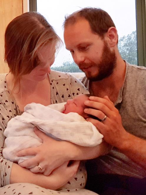Holding the first New Year’s Day baby born in Otago by just a few minutes are parents Ben and...