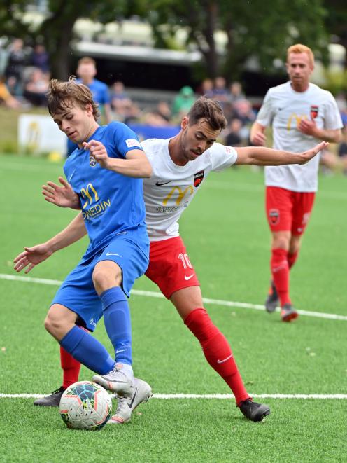 Southern United's Adam Hewson (left) and Canterbury United's Reece Dalton fight for the ball at...