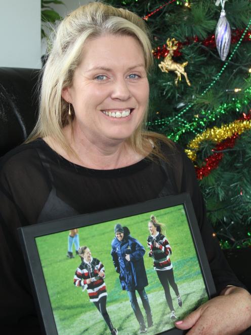 Melissa Vining holds one of her favourite photos of her late husband Blair and daughters Lilly ...