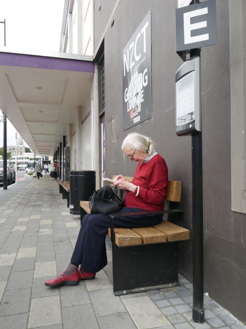 Gisela Andrew, of Dunedin, waits for her bus at the Great King St hub on Tuesday. PHOTO: JESSICA...