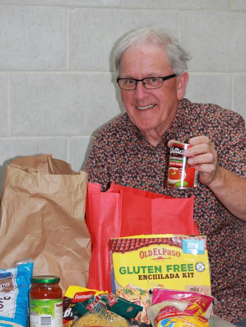 Society of St Vincent de Paul Dunedin volunteer Charlie Pringle packs another food parcel for a...