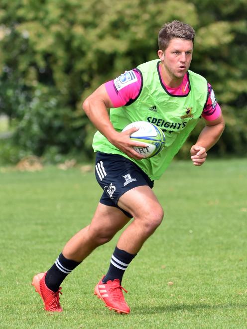 Highlanders second five-eighth  Tei Walden runs the ball at training yesterday as the side...