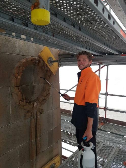 Stoneface Ltd’s Taylor Coulthard spraying the natural stone atop the 14-metre high cenotaph in...
