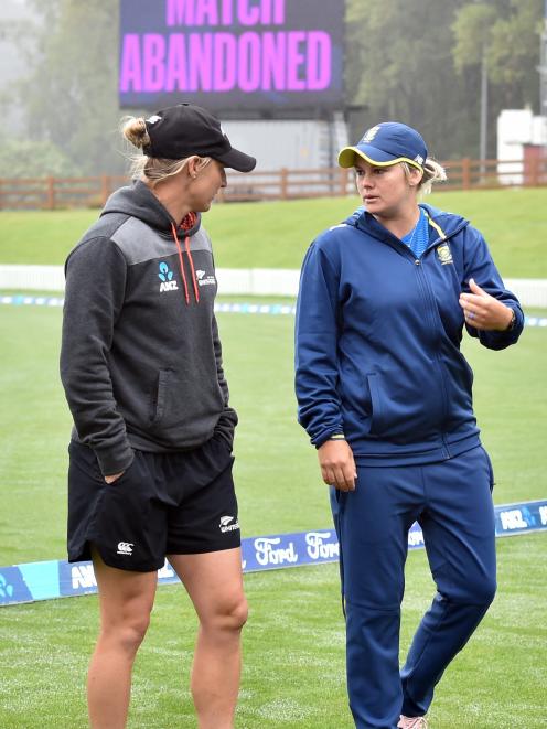 New Zealand captain Sophie Devine and South African opposite Dane van Niekerk wander off after...