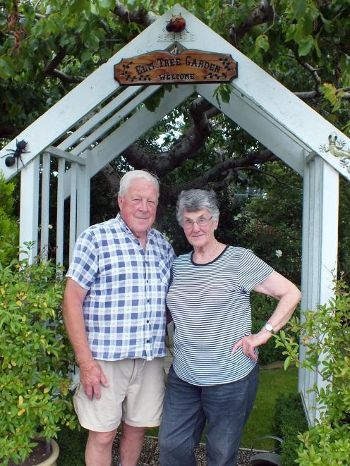 Richard and Myra Wells in front of the elm tree that gives their Abbotsford garden its name. 