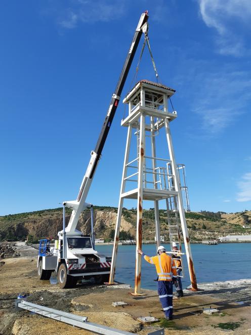 A telehandler is used to take the Oamaru Harbour breakwater navigational aid away to be treated for rust. Photo: Supplied