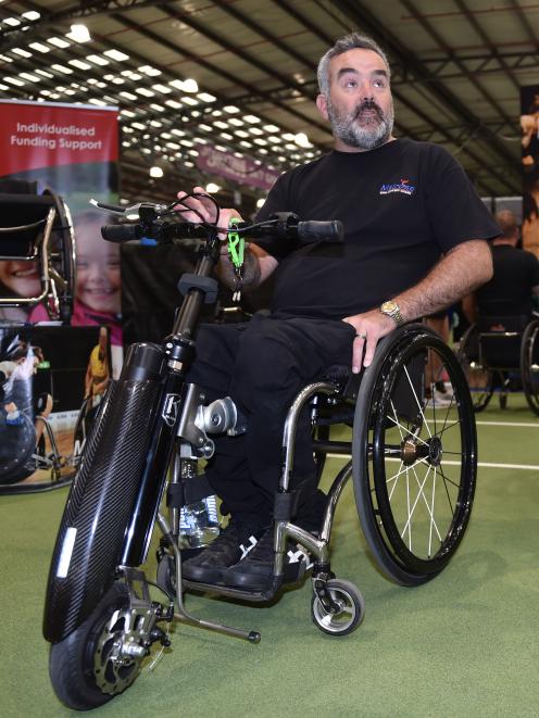 Melrose sales manager Chris Hanley shows off a wheelchair power add-on   at the Show Your Ability expo in  Dunedin yesterday. Photo: Gregor Richardson