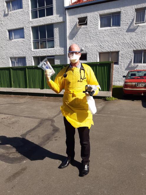 Dunedin North Medical Centre doctor Daniel Pettigrew dresses as he would to test a patient for...