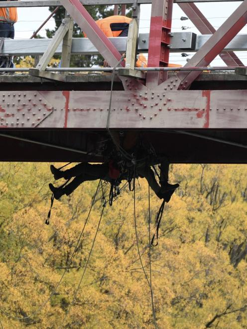 Hanging out . . . Fulton Hogan contractors work above and below the deck of Luggate’s Red Bridge...