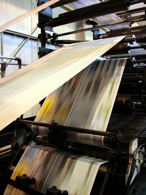 Newspapers make their way through the press at Allied Press in Dunedin. Photo: ODT files 