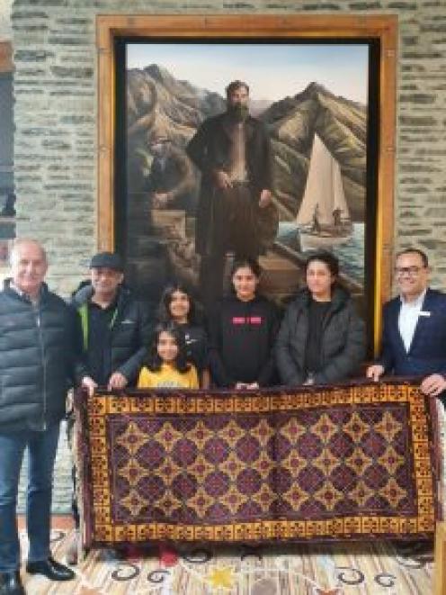 Yama Nabi presented a handmade rug to The Rees Hotel. His family are pictured with manager Mark...