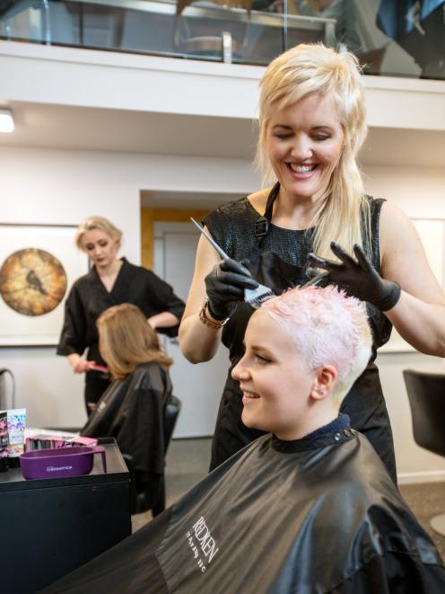 Nearly back in business ... Timely client Kylie Hayes, of Moha Hairdressing, cuts hair before the...
