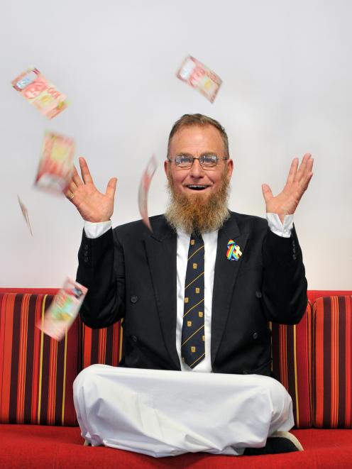 New Zealand Education Foundation director Paul Gourlie with $1000 he never knew he had. PHOTO:...