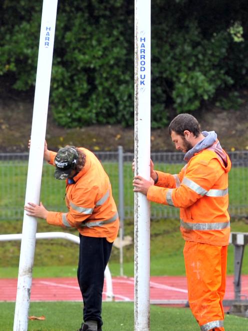 Delta workers Simon Smaill (left) and Will Young  get ready to put in the goalposts for the...