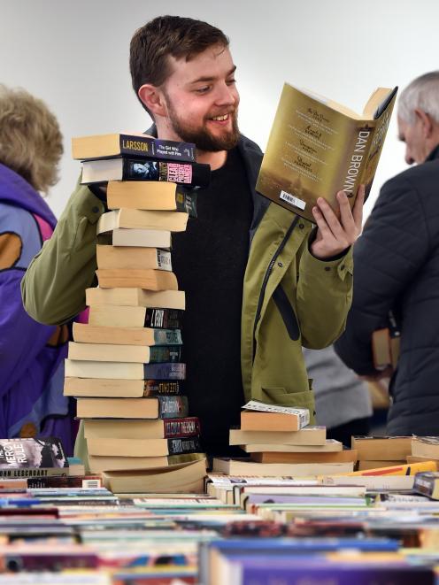 Student Jake Ward (23), of Dunedin, with his stack of books, during the Regent Theatre Pop-up...