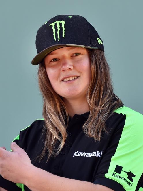 Champion motocross rider Courtney Duncan shows off the trophy presented to her for winning the...