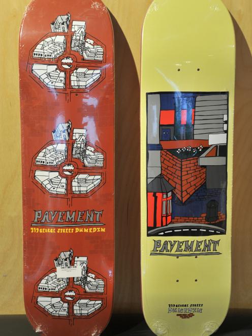 A skateboard depicting the Octagon, painted by Callum Parsons, and another depicting the Library...