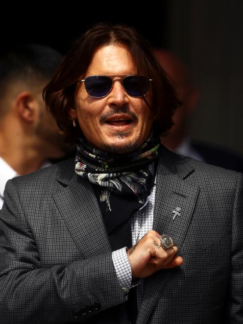 Johnny Depp acknowledges fans outside the court. Photo: Reuters 