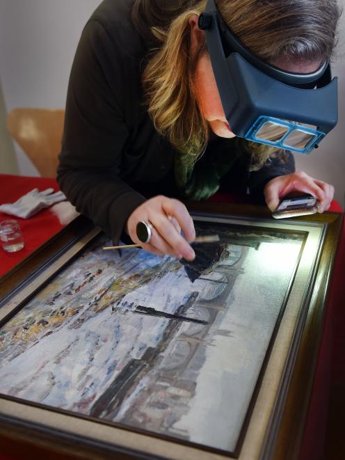 Dunedin Public Art Gallery conservator Jenny Sherman demonstrates a cleaning technique