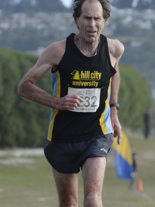 Philip Morris approaches the finish line to win the Barnes cross-country senior men’s race at...