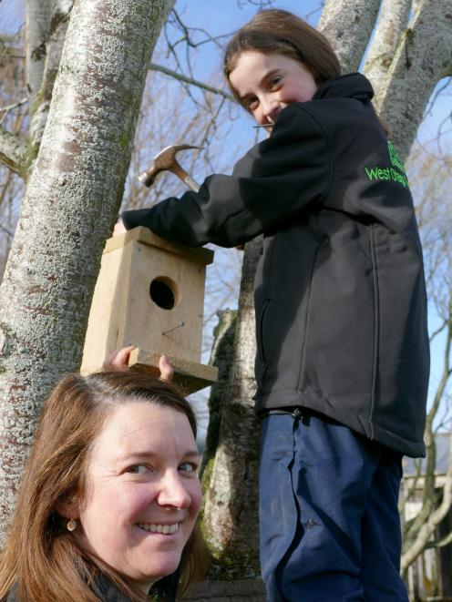 Zita Young helps her daughter Amy  put up the bird box she made during a recent West Otago Rural...